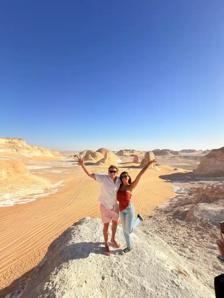 Travelers celebrating at a White Desert viewpoint in Egypt