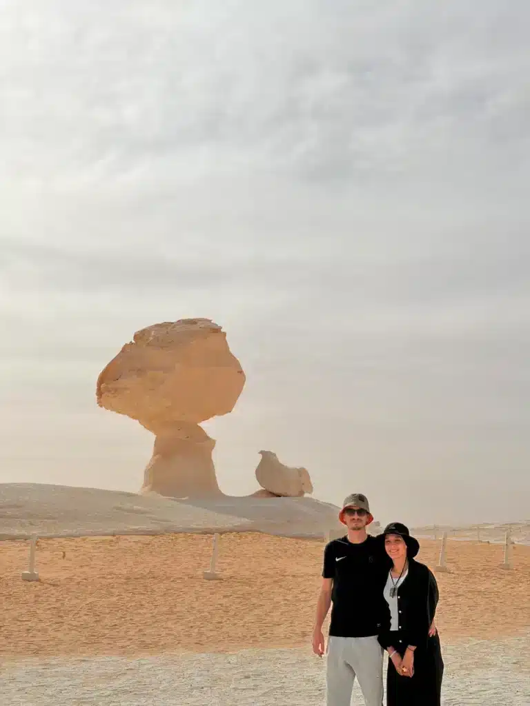 Couple at Mushroom Rock and Chicken Rock in the White Desert