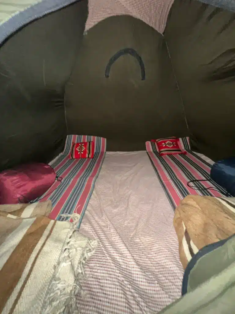 Beds with mattresses and blankets inside a tent at the eclipse camp