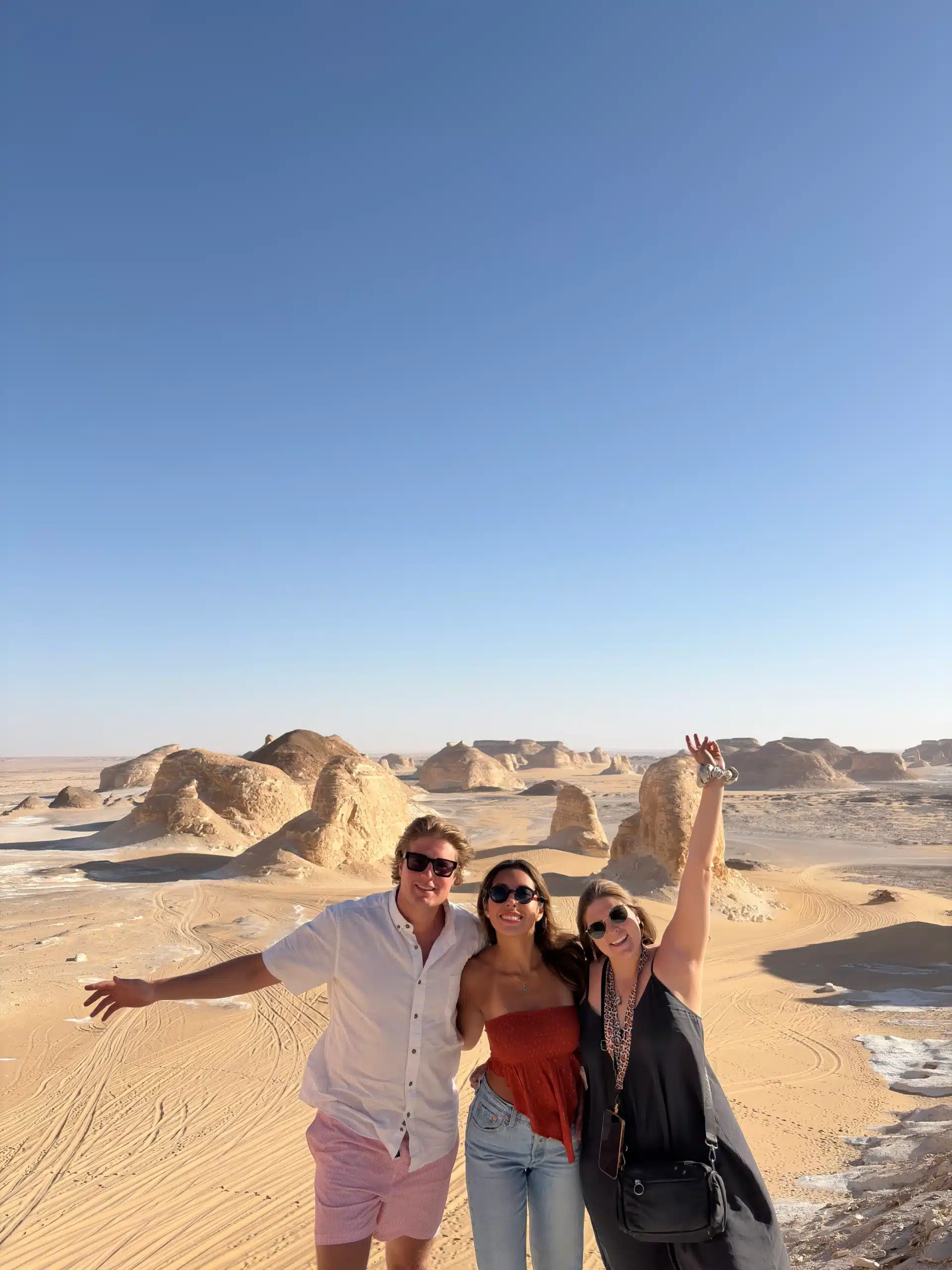 Friends enjoying a viewpoint overlooking the White Desert landscape in Egypt