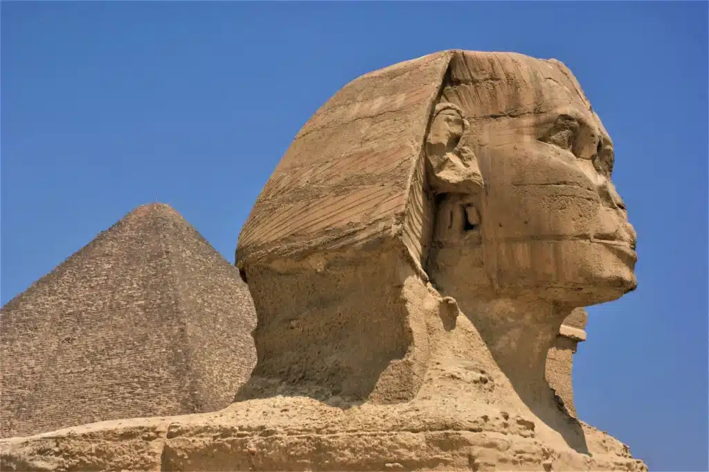 Great Sphinx close-up with a pyramid behind, Giza