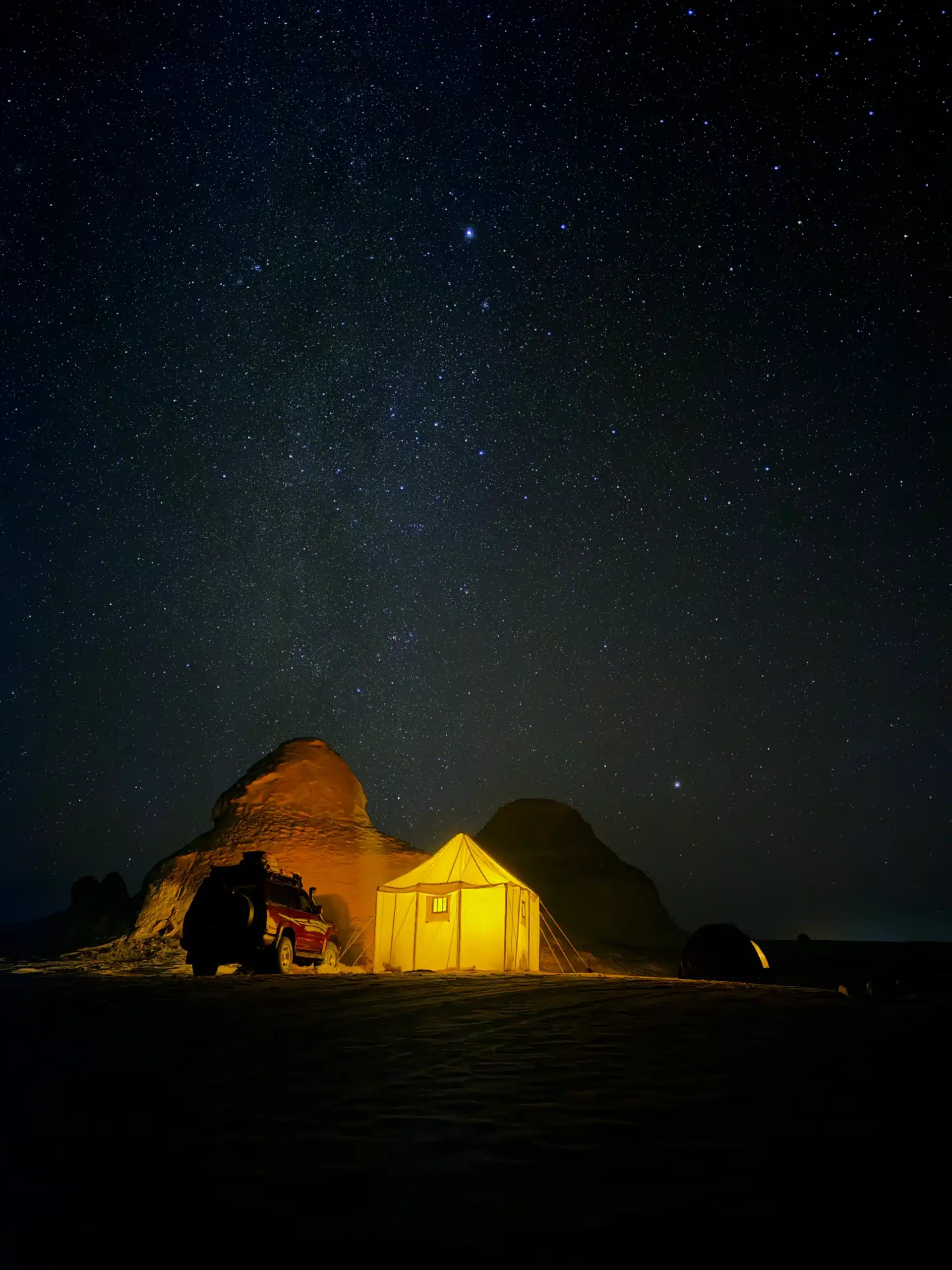 Illuminated desert camp beneath the stars in Egypt