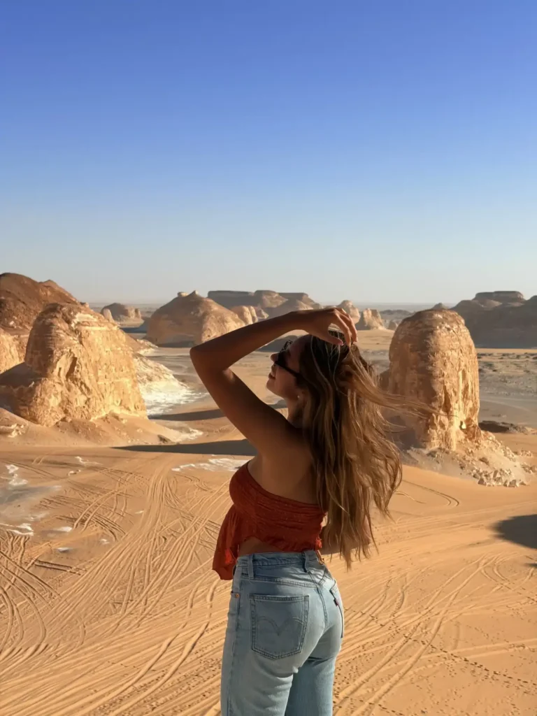 Traveler looking over Agabat Valley at the edge of the White Desert