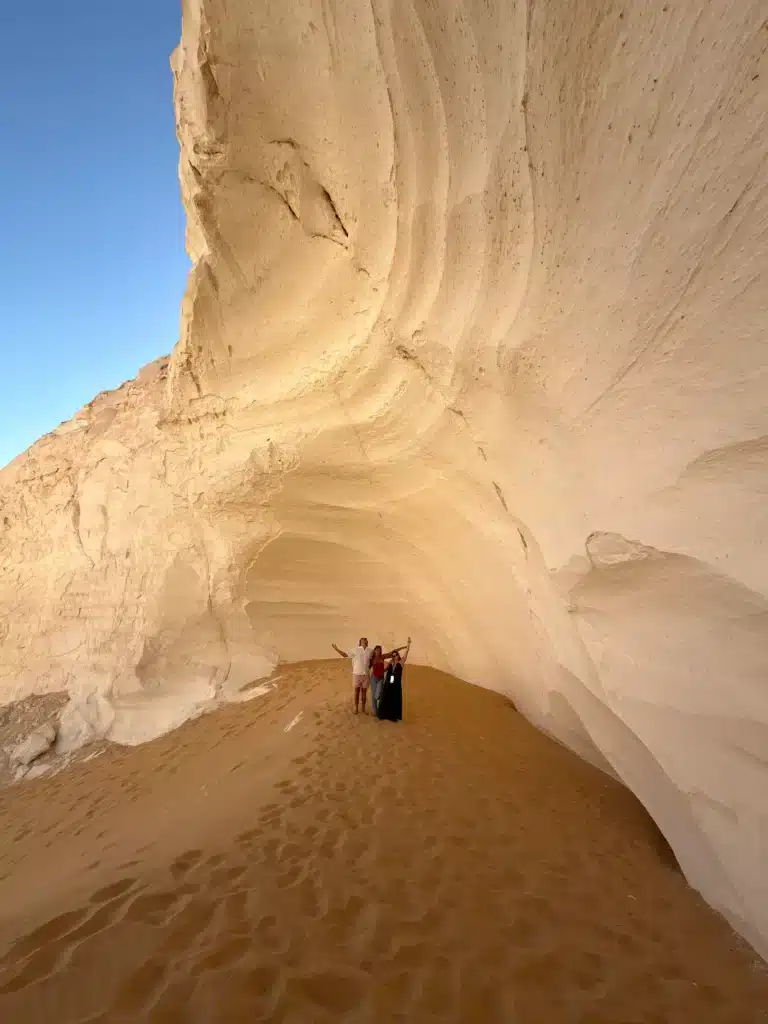Travelers inside a giant chalk cave on a 4-day White Desert tour
