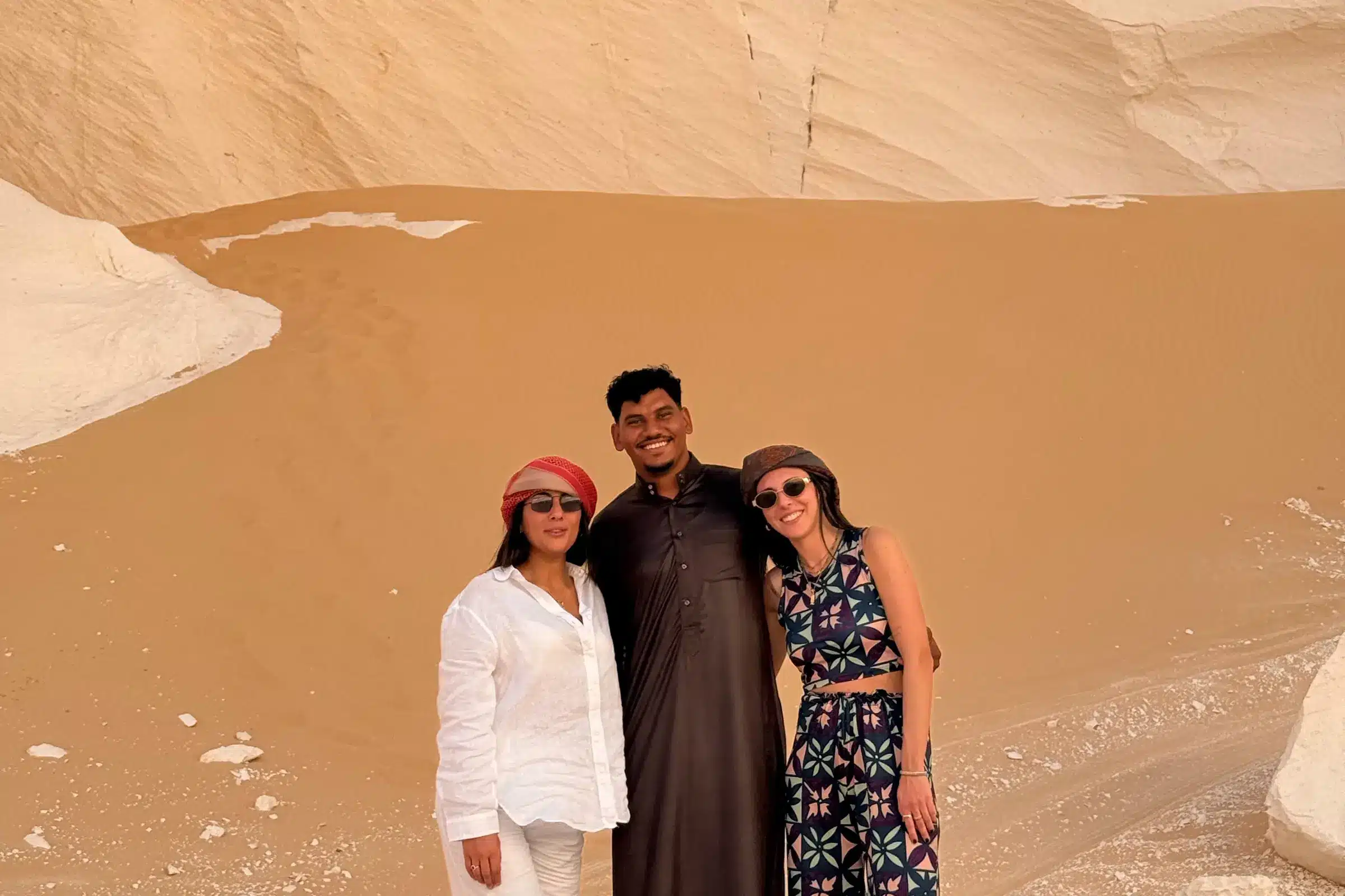 Travelers beneath a chalk cliff in the White Desert