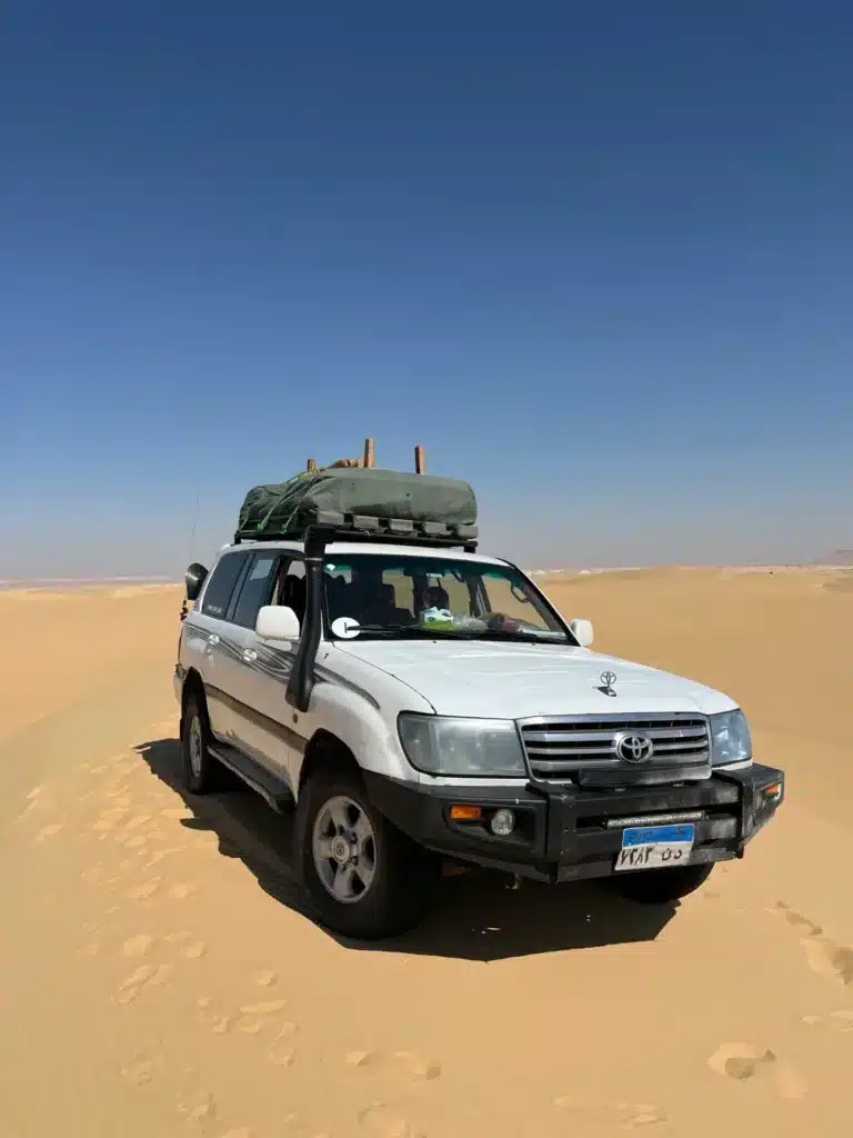 4x4 desert vehicle driving through the White Desert on the eclipse safari