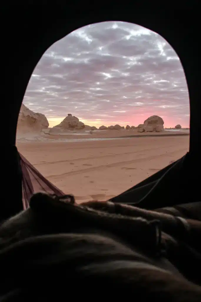 White Desert sunset seen from inside a camp tent